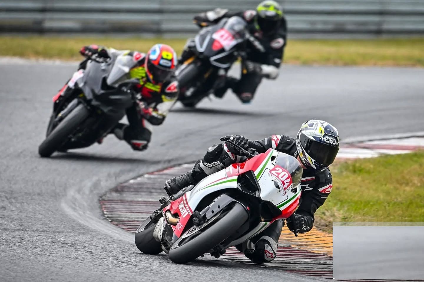 Riders cornering in convoy at a UK track day