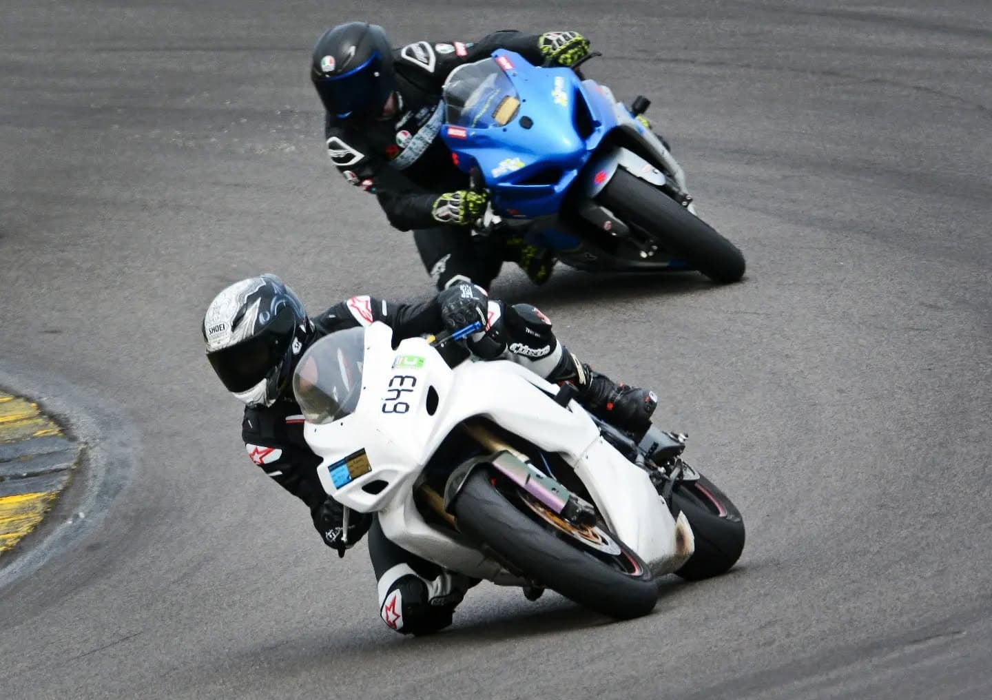 Two riders chasing through a corner at a UK track day